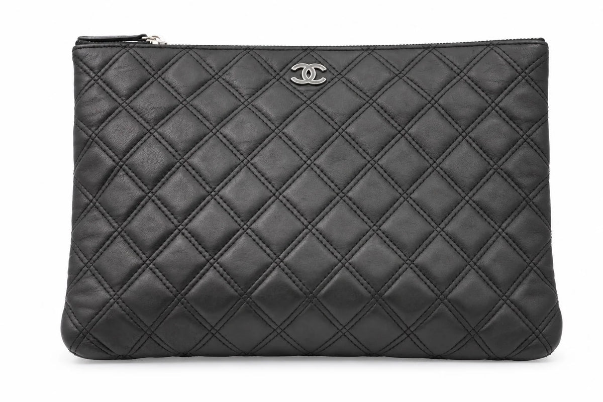 CHANEL black quilted caviar leather O-Case clutch front view | Shop Authentique Lux