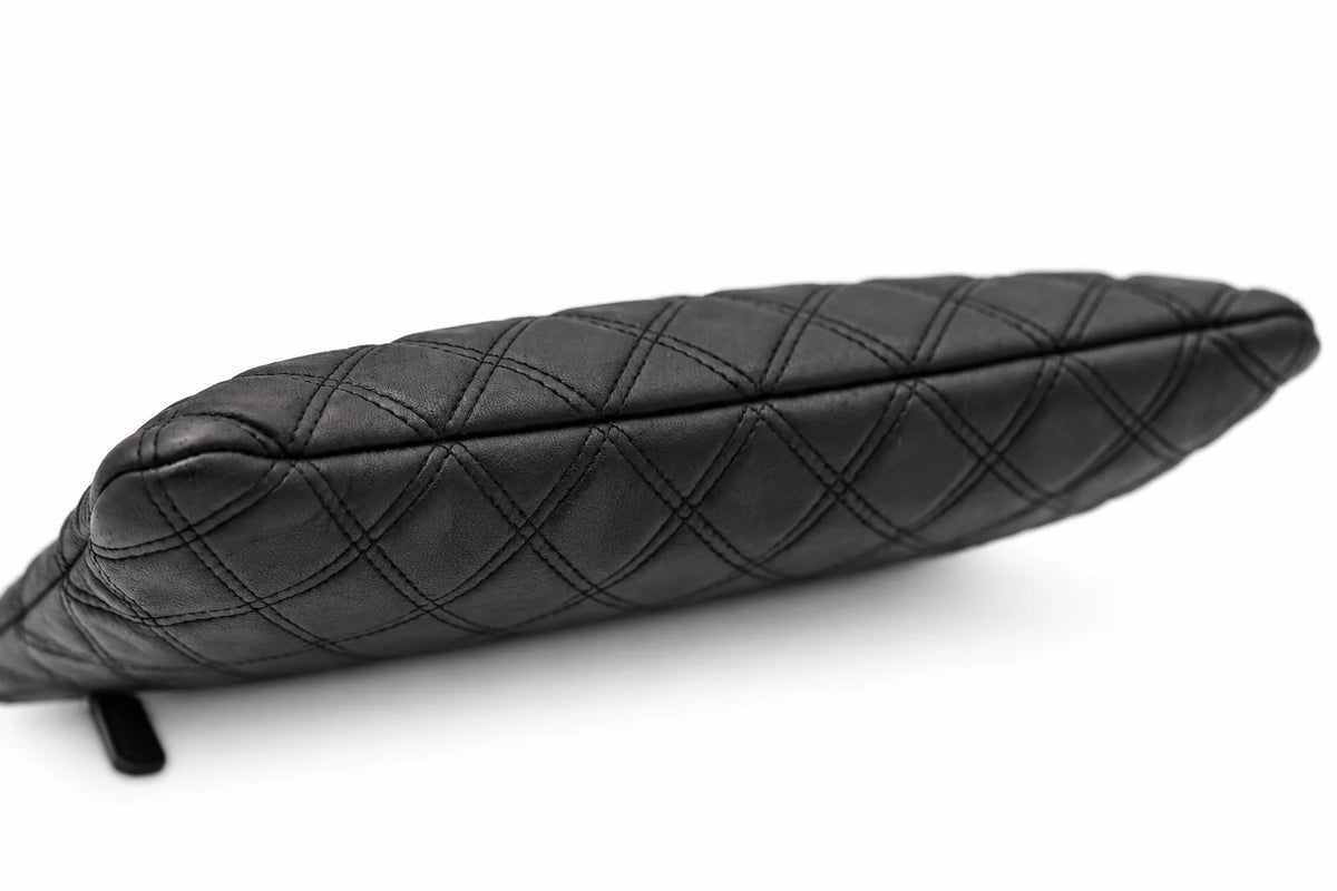 CHANEL black quilted caviar leather O-Case clutch angled view | Shop Authentique Lux