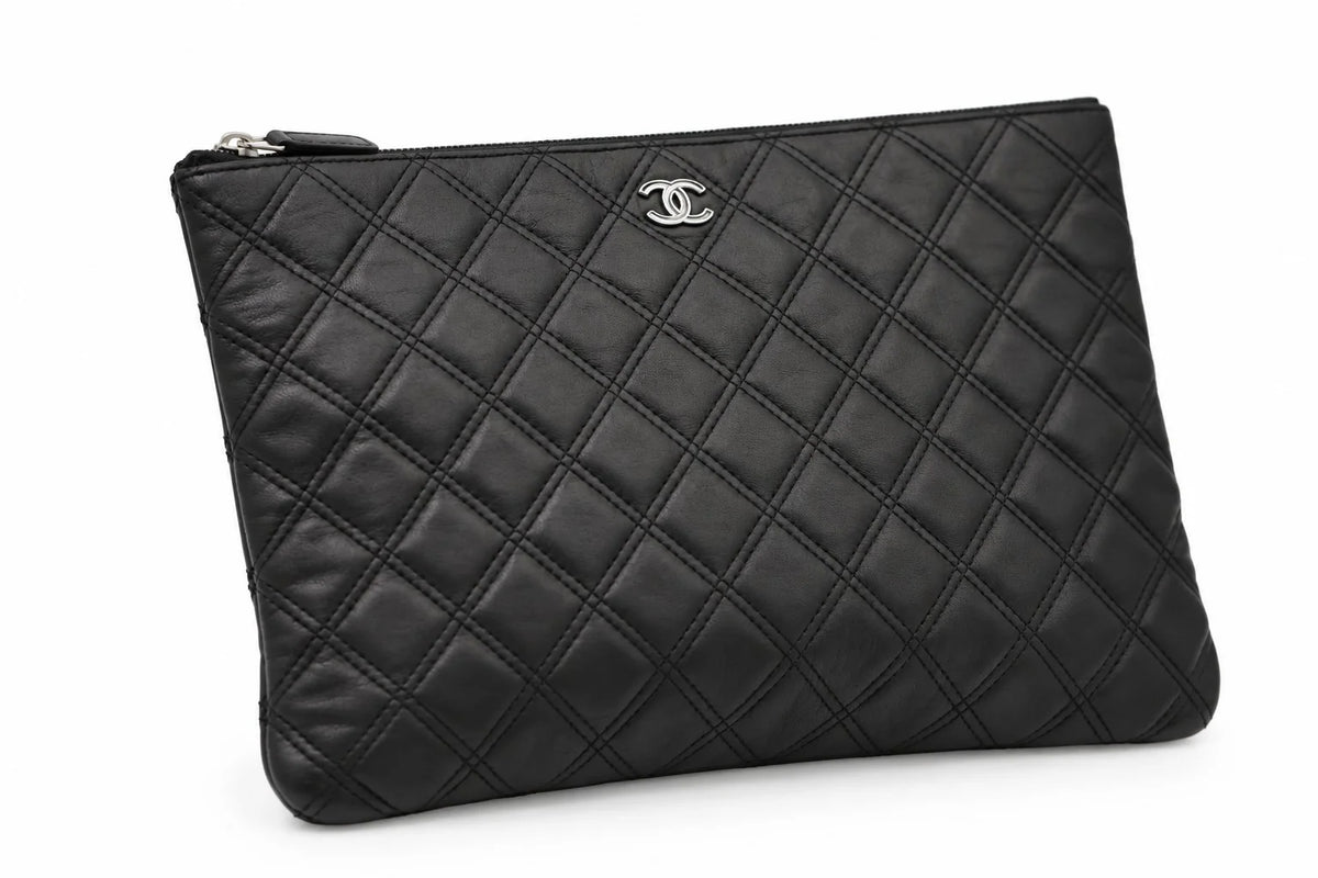 CHANEL black quilted caviar leather O-Case clutch base view | Shop Authentique Lux