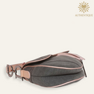 Vintage Christian Dior Saddle Bag in blue denim with pink patent leather trim and silver-tone 'D' charm hardware. Shop Authentique Lux