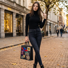 Model wearing Gucci Night Courier GG Supreme Soft Tote in Black Monogram – Available at Authentique Lux
