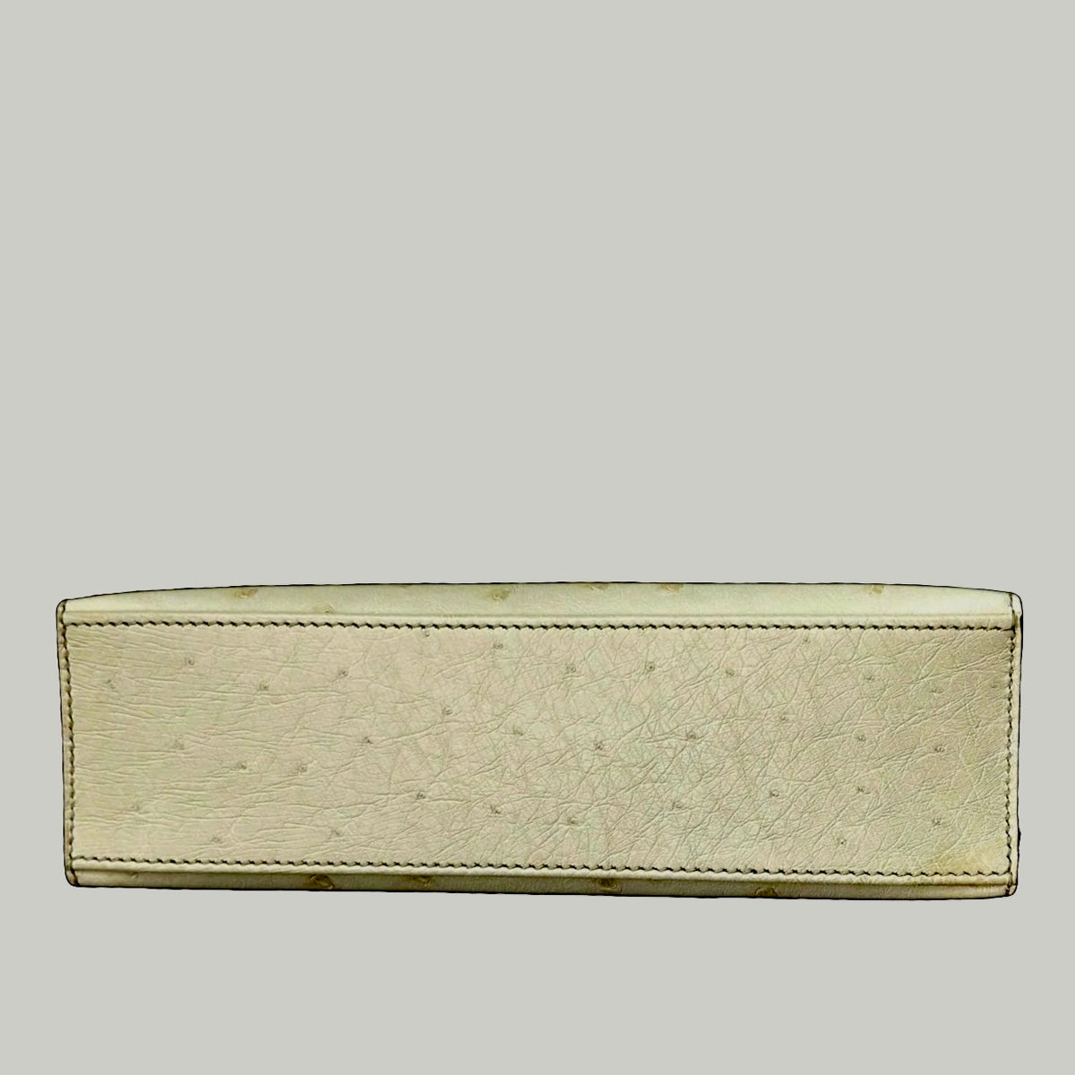 HERMÈS Beton ostrich Kelly Pochette, rear view and top handle | Shop Authentique Lux