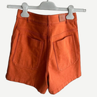 HERMÈS Orange Stretch Denim Shorts, Calfskin Detail | Shop Authentique Lux