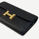 HERMÈS Noir Constance To Go, angled front view with gold H clasp | Shop Authentique Lux