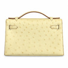 HERMÈS Beton ostrich Kelly Pochette, base and stitching | Shop Authentique Lux