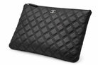 CHANEL black quilted caviar leather O-Case clutch angled front | Shop Authentique Lux