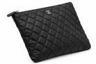 CHANEL black quilted caviar leather O-Case clutch side angle | Shop Authentique Lux